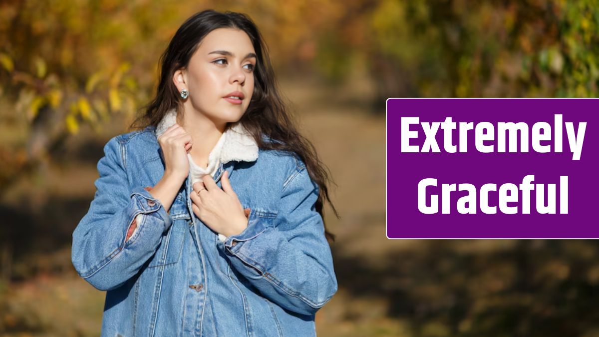 Portrait of beautiful young woman walking outdoors in autumn park.